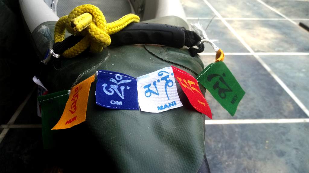 Prayer flags adorn the canoe