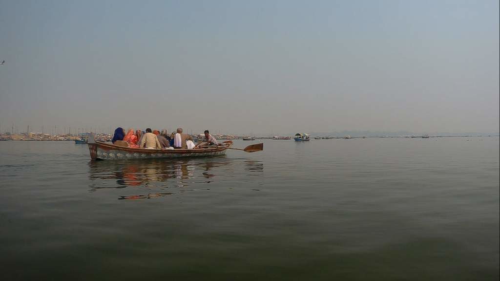 Each boat of pilgrims sing bhajans